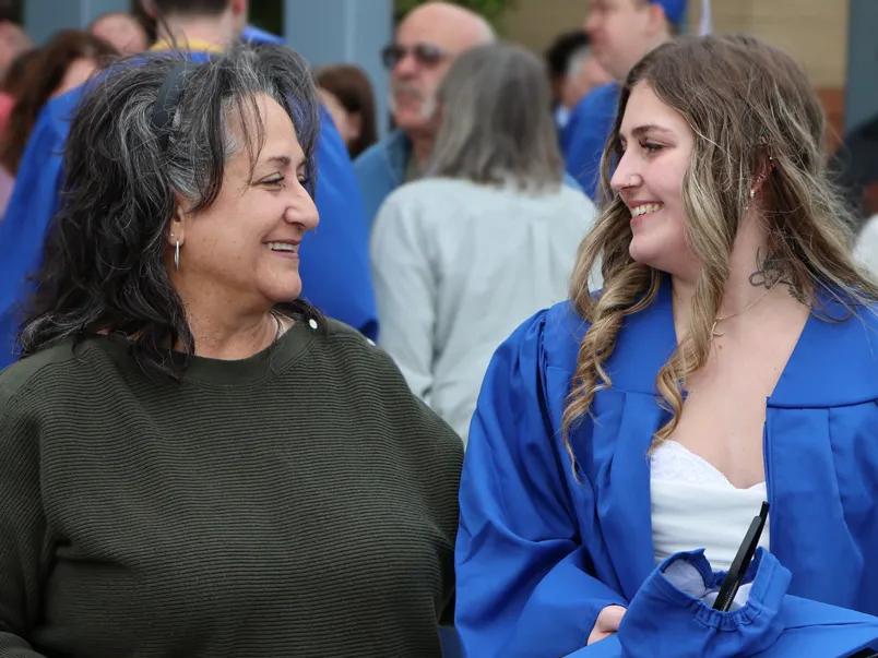 A mother and daughter share a moment at Commencement.