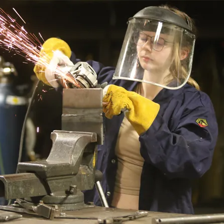 Emma welding in Mid's Lab on the Harrison Campus.