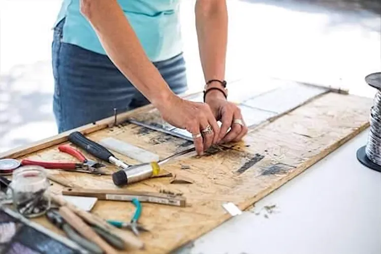 Woman's hands working on a stained glass piece of art
