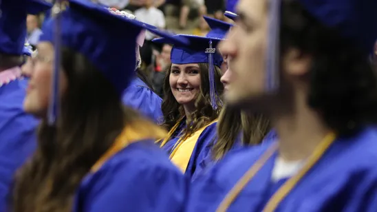 A Mid Michigan College graduate celebrates with classmates.