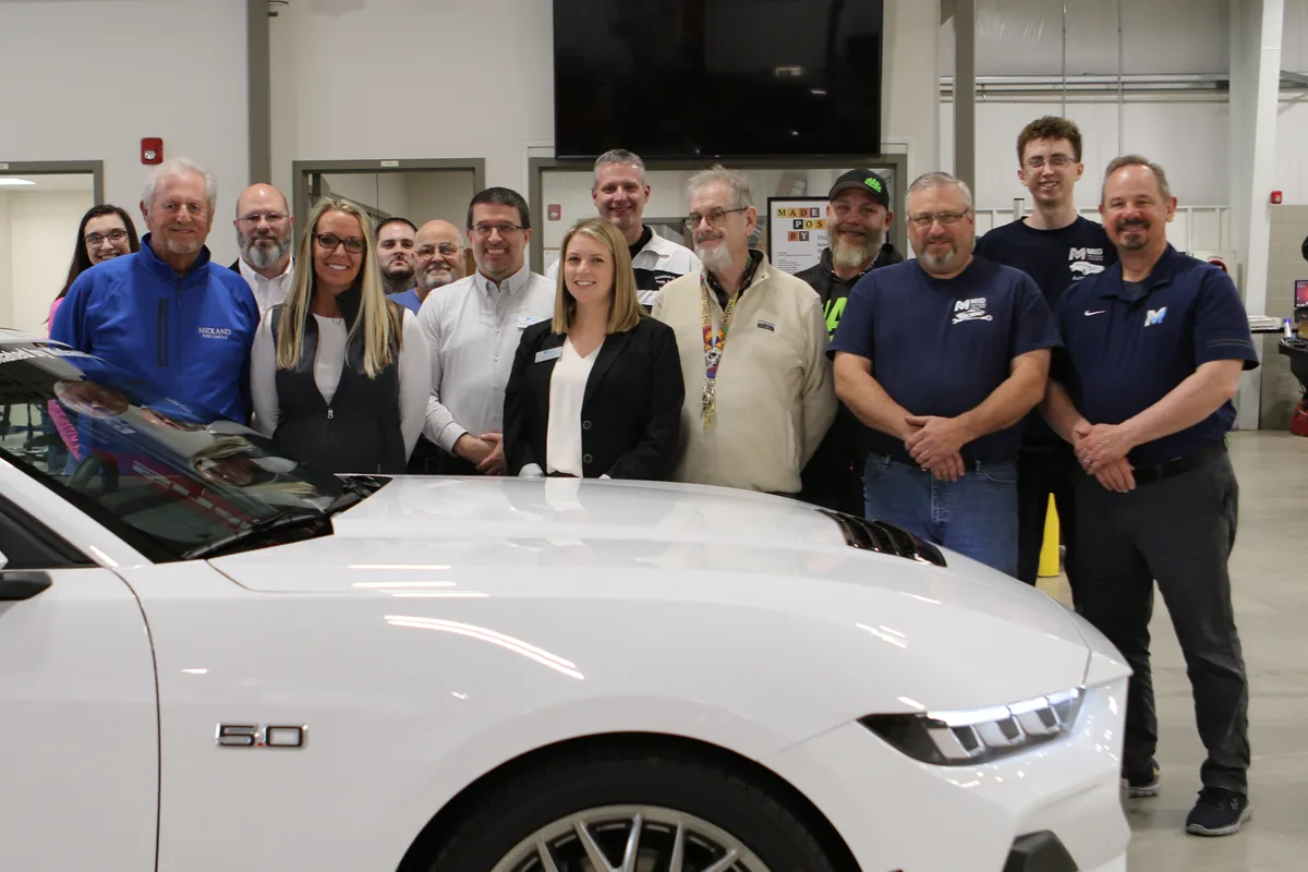 Group surrounds donated 2024 Ford Mustang from Midland Ford Lincoln.