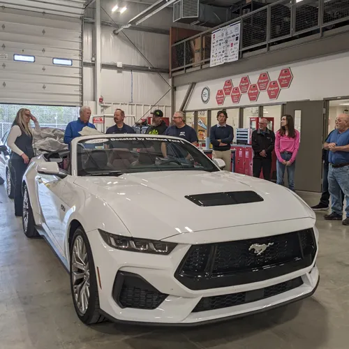 Group surrounds donated 2024 Ford Mustang from Midland Ford Lincoln.