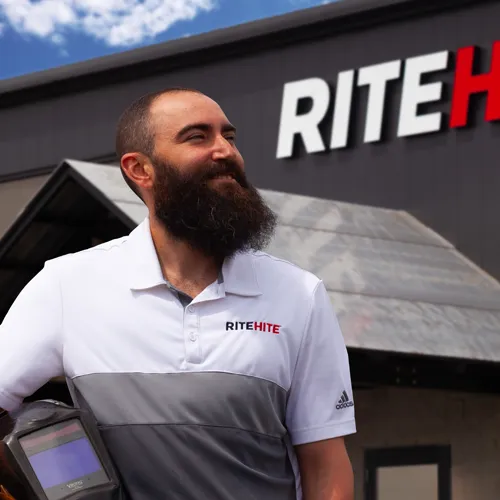 Mid graduate, Aaron Peever, stands in front of Rite-Hite in Clare.