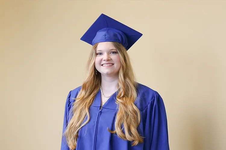 Mid Student Meradith Anderson wearing cap and gown